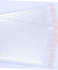 Close-up of 25 Pack White Bubble Mailers Self Seal Padded Envelopes 24x35+5cm Waterproof Shockproof Packaging Bags on a white background.