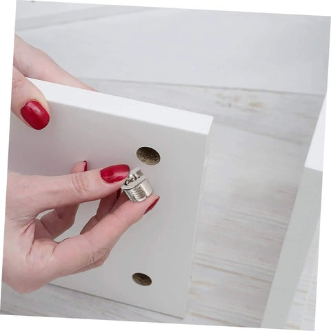 Heavy Duty Eccentric Cabinet Connectors And Screw In Dowel Pins Dead Nuts inserted into a white cabinet panel hole.