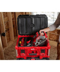 Person holding M12 Fuel 5-3/8 Inch Circular Saw Cordless With Brushless Powerstate Motor And REDLINK Plus Intelligence in a toolbox