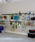 Garage interior with FastTrack Wall Double S Hook Garage Organizer Set, 2 Pack For Hand Tools holding various items on rails and shelves.