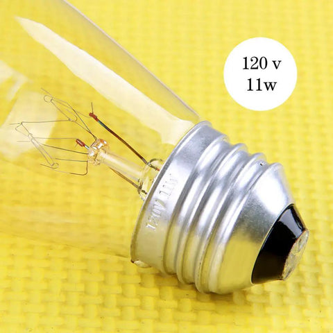 Close-up of a clear S14 vintage bulb on yellow background, showing filament and 120V 11W label for 30 Pack S14 Outdoor String Light Bulbs Set Orange Clear Vintage Shatterproof 11W 120V Replacement Bulbs For Patio Backyard Party Lighting For Easy Outdoor Decor And A Lit Vibe.