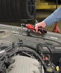 Heavy Duty M12 Three Eighth Drive Cordless Ratchet Battery Operated Power Tool Boasting Kickass Torque and Rock Solid Build being used in a garage.