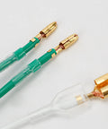 Close-up of 50 pack double spade wire connectors for motorcycle wiring, 2 to 1 splice, 4mm bullet crimp terminals, transparent sleeve.