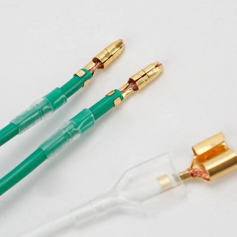 Close-up of 50 pack double spade wire connectors for motorcycle wiring, 2 to 1 splice, 4mm bullet crimp terminals, transparent sleeve.