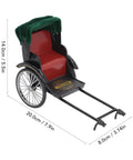Vintage Red Zinc Alloy Rickshaw Model Toy With Sick Hand Painted Details And A Clean Finish That Hits Different On Any Desk Or Mantle Shelf Perfect Collectible Piece For Home Decor Or Thoughtful Gift Displays, showcasing red seat and green canopy.