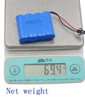 Two Pack 4.8V 800mAh NiCd RC Battery Pack weighing 69.4g displayed on digital scale
