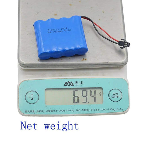 Two Pack 4.8V 800mAh NiCd RC Battery Pack weighing 69.4g displayed on digital scale