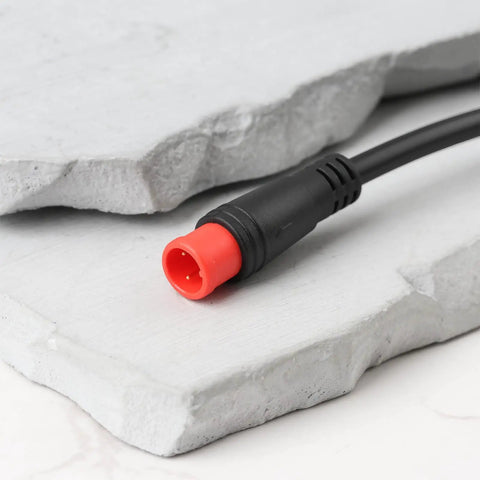 Close-up of red 2-pin connector on 2 Pin E Bike Light Throttle Waterproof Extension Cable 56 Cm Long For 52V 48V 36V E Bike Motors