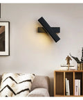 Elevate Your Home Vibe With This Sleek Black Metal Swivel Wall Sconce Led Lighting For Bedroom Living Room And Hallways Rustproof Adjustable Accent Lamp on a wall above a cozy sofa.
