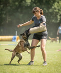 Trainer using Dog Bite Sleeve Training Pro Grade For Large Dogs Heavy Duty Jute Gear With Safe Padded Arm Sleeve during dog agility exercise