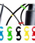 Multipurpose Alloy Bicycle Brake Line Clamps And Cable Clips For Road Bikes in multiple colors and installed on bike cables.