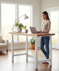 Rock Solid Height Adjustable Workbench With Premium Hardwood Surface And Hella Heavy Duty Steel Base Tough Garage Workstation For Daily Shop Jobs And Comfortable Ergonomic Workflow 48 X 24 Inch Table in home office setting with woman typing.