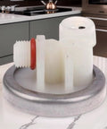 Coffee Machine Pressure Regulator For Stable Water Flow And Durable Beverage Making Component That Eliminates Pulsation From Electromagnetic Pumps Delivers Smooth Extraction And Home Barista Quality, white plastic and metal part with red seal