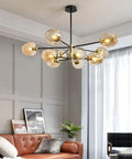 5-Light Sputnik Chandelier With Airblown Glass Globes In Sleek Smoke Grey in modern living room above sofa.