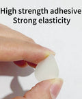 Close-up of a hand holding a single white PVC cover cap from the 580 Piece Self Adhesive Screw Hole Stickers Set For Wooden Furniture And Cabinets