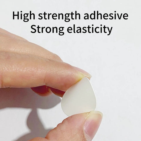 Close-up of a hand holding a single white PVC cover cap from the 580 Piece Self Adhesive Screw Hole Stickers Set For Wooden Furniture And Cabinets