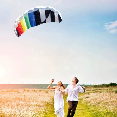 Couple flying Rainbow Parafoil Kite 55 Inch Pro Stunt Soft Foil with 1.4 M Wing Span in open field; colorful design, easy to fly