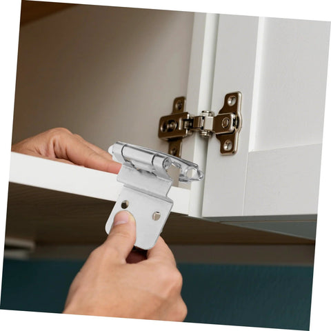 Installed view of 8-piece Unomor self-closing inset cabinet hinge set; silver hinges on white cabinet door