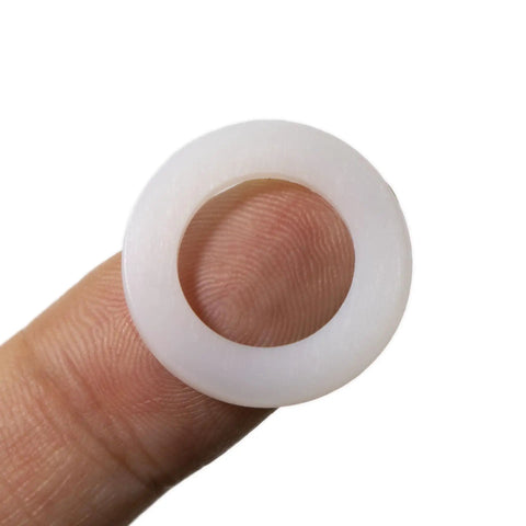 Heavy Duty Nylon Flat Washers Assortment Kit For Mechanical And Electrical Jobs, Top Shelf White Plastic Pa66 Insulating Hardware For Metric Screws And Bolts, 720 Piece Rock Solid Pack, shown held between fingers.