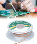 Person using Pro Grade Alloy Copper Desoldering Braid for electronics repair and PCB work, spool showing 1.5m length, 1.5mm width