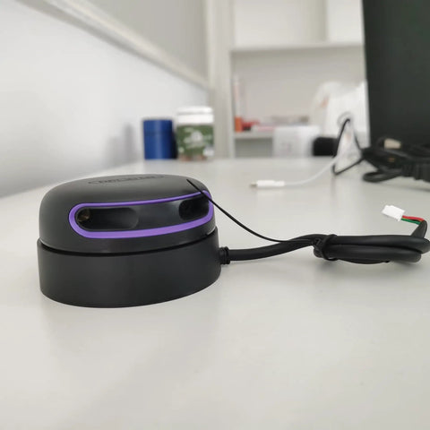 RPLIDAR A2M12 360 Degree Lidar Scanner for Robotic Mapping and Navigation on a desk, black with purple accents, wired