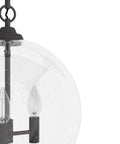 Close-up of High Oaks 3-Light Noble Bronze Pendant Light with dimmable fixture, featuring dope globe seeded glass shades.