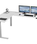 Super Smooth White Corner Standing Desk With Dry Erase Surface L Shaped Sit Stand Workstation 83 By 60 Inches showing dual monitors and accessories.