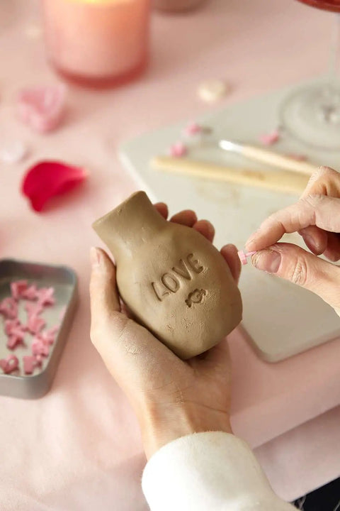 Hands sculpting with Date Night Special Edition Air Dry Clay Kit For Adults With Tools Paints Brushes Sealant And How To Guides