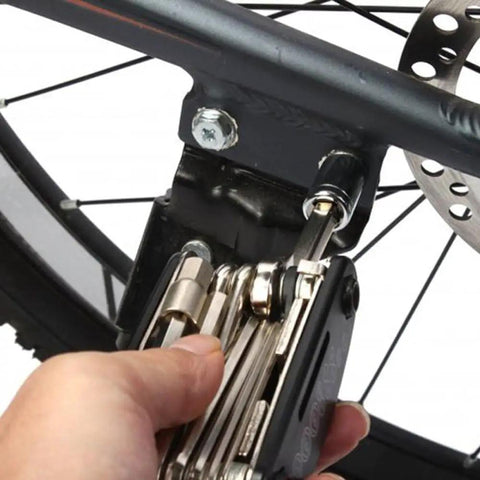 Using Bike Repair Tool Kit 16 In 1 For Quick Fixes with hex wrench on bike wheel bolt