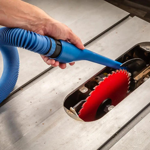 15 Inch Click Connect Needle Nose Crevice Tool for Shop Vac Vacuum Cleaner being used near a workshop table saw blade.