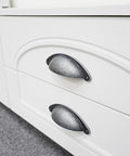 10 Pack 3 Inch Cabinet Cup Pulls Matte Black Swedish Iron Drawer Hardware installed on white cabinet drawers