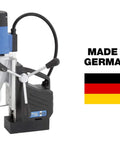 Portable Dual Gear Magnetic Drill Press 110V Made In Germany With 2 Inch Hole Capacity, display with German flag