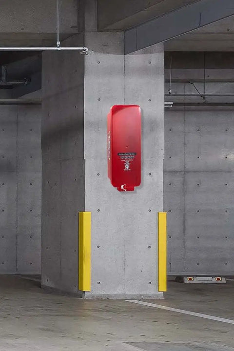 Built Tough Red Surface Mount Fire Extinguisher Cabinet With Lock Down Door And Quick Grip Pull Cover For Heavy Duty All Weather Outdoor Safety Setup Box mounted against a concrete wall.