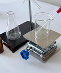 Stainless steel lab jack stand with 4x4 in square platform and blue knob, front view