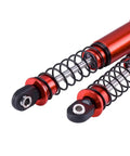 Close-up of red 85mm aluminum big bore shocks for 1/10 RC crawler, dual-spring, durable for rough terrain with smooth damping.