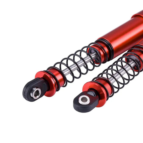 Close-up of red 85mm aluminum big bore shocks for 1/10 RC crawler, dual-spring, durable for rough terrain with smooth damping.