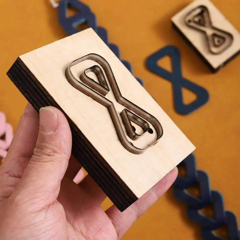 Dope Bow Shape Leather Cutting Die Set Two Pack For DIY Leather Projects shown in hand with wooden frame and Japanese steel blades.