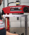 20 Ton Hydraulic Shop Press with Dual Air Motor and 7 Position Bed Height, shown in red frame with polycarbonate shield