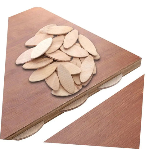 Stack of light brown wood biscuits on a wooden surface from Beech Wood Biscuit Joining Set 100 Pcs Tenon Joint Tool Kit For Woodworking Cabinetry And Carpentry Premium Biscuit Connectors For Strong Plywood And Panel Joints DIY Docking And Frame Assembly For DIYers And Pros