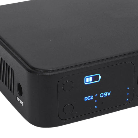 Close-up of Heavy Duty UPS Battery Backup With Massive 18000 Mah Reserve, showing input ports and battery charge indicator.
