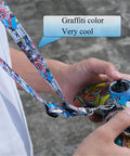 Person holding remote with Adjustable Drone Controller Neck Strap With Wide Compatibility For Avata 2 Avata FPV Remote Controller 3 2 Phantom 3 4 Pro Sling Lanyard For Keys ID Cards Game Console Anti Drop Comfort Graffiti Look in graffiti color