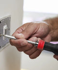 Person using Multi Screwdriver 13 In 1 Set With 1/4 Nut Driver And 12 Bits Including Torx Security for quick DIY fix on light switch