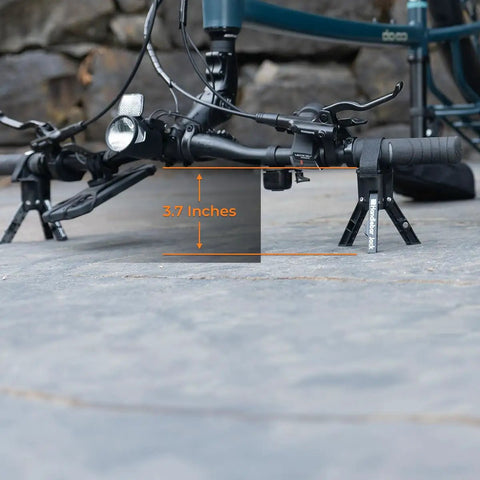 Handlebar Jack V3 Portable Repair Stand lifting bike handlebar 3.7 inches off ground, showcasing stability and secure cradle support.