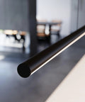 Close-up of Contemporary LED Hanging Pendant Light Bar, 72 inch, black finish, designed for kitchen island or dining room.