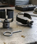 Heavy Duty Three Piece Drain Auger Set Featuring Tough As Nails Steel Cutter Heads on a workbench, showcasing metal rotary cutters.