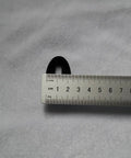 Close-up of Fuchi Kashira Iron Alloy Set For Samurai Tsuka Handle Ferrule Caps 01 To 07 with ruler for size reference.
