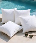 Outdoor Pillow Inserts 18x18 Pack Of 4 Waterproof Cushions For Patio And Porch Furniture shown by a poolside with water droplets
