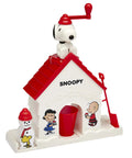 Snoopy House Snow Cone Machine For Kids Hand Crank Shaved Ice Maker With Fruit Punch Flavor Pack Easy Setup Summer Cooling Toy For Ages 6 Up White build with Snoopy on roof.