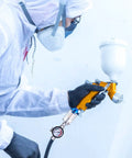 Person using a spray gun equipped with Two Pack One Quarter Inch Air Pressure Regulator And Water Separator Kit For Air Compressors Pro Grade Gear
