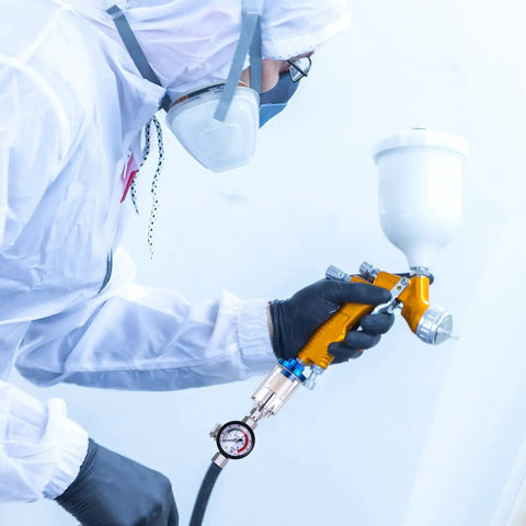 Person using a spray gun equipped with Two Pack One Quarter Inch Air Pressure Regulator And Water Separator Kit For Air Compressors Pro Grade Gear